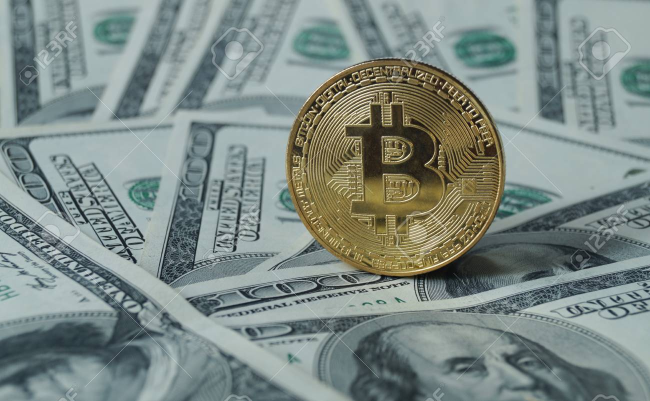 A Symbolic Coins Of Bitcoin On Banknotes Of One Hundred Dollars - 